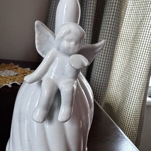 White Cherub sitting on Bell